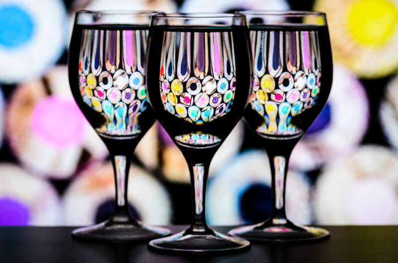 still life photography three glasses in front of colored pencils